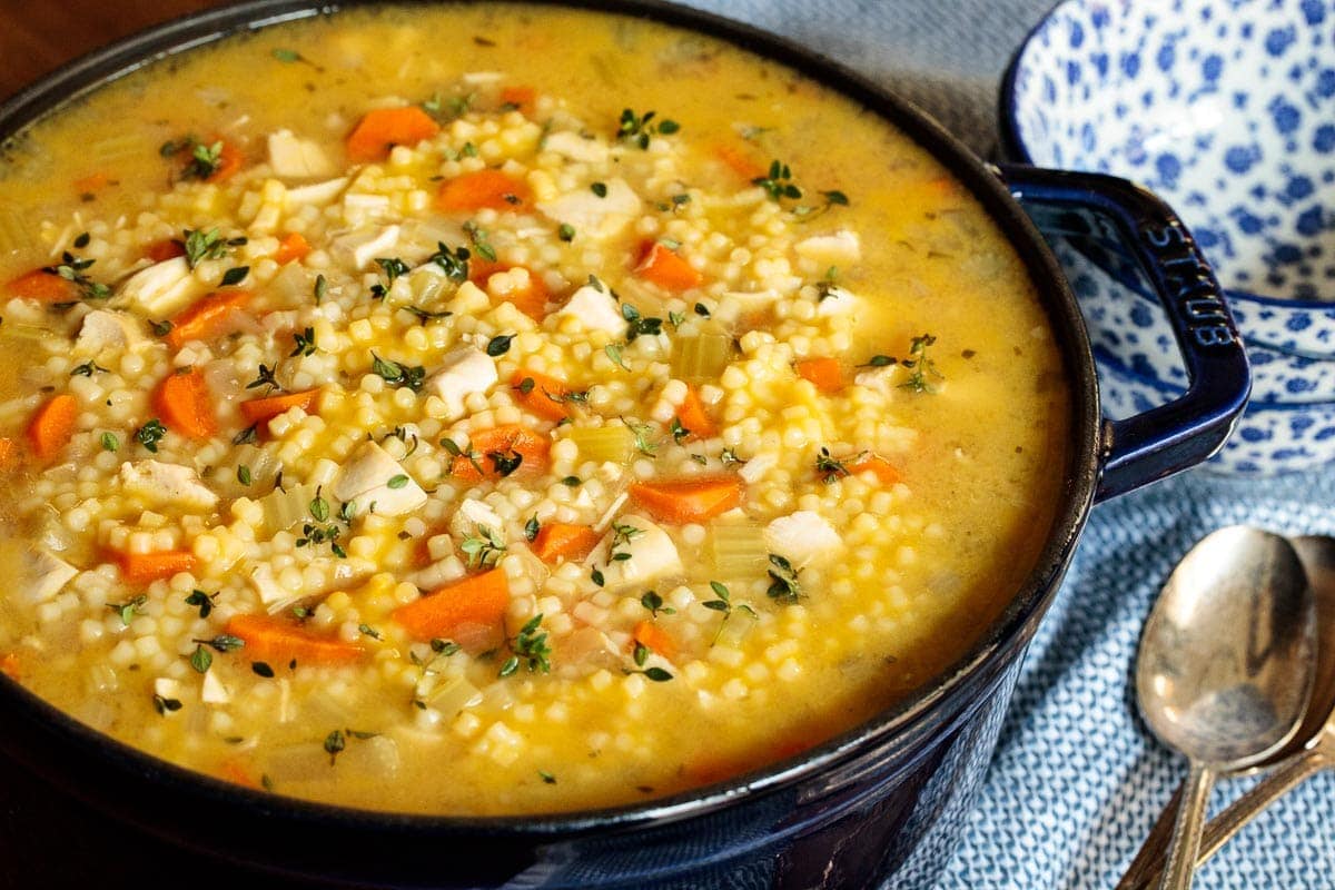 Picture of a Dutch oven filled with Homemade Chicken Pasta Soup.