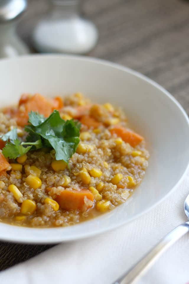 Corn, quinoa and sweet potato chowder in a shallow white bowl