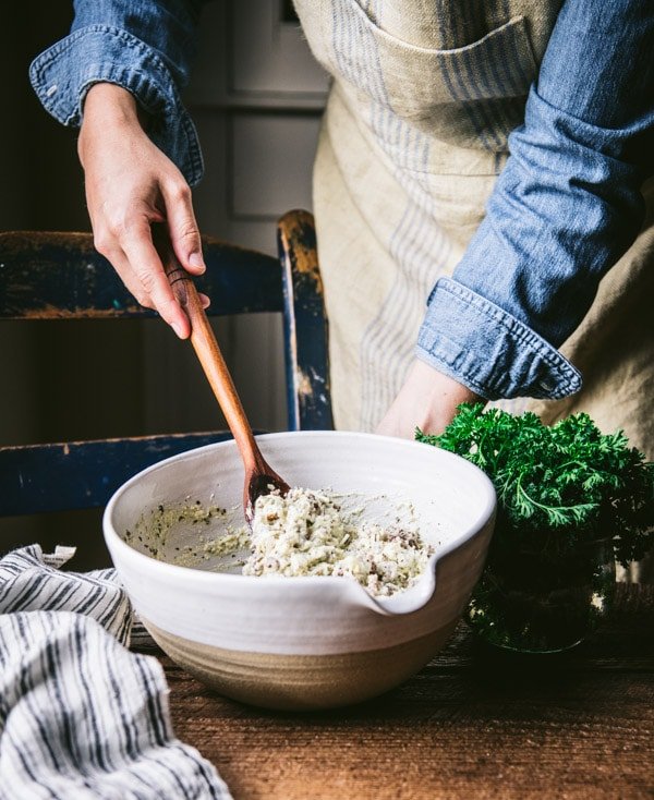 Stir ricotta cheese mixture in a white bowl