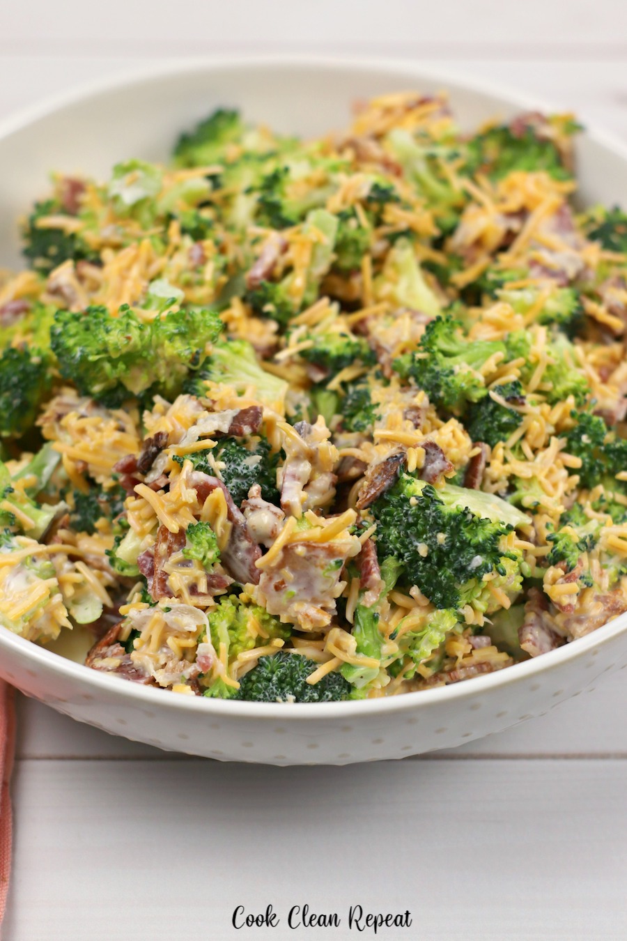 A third full bowl of broccoli salad is complete and ready to enjoy.