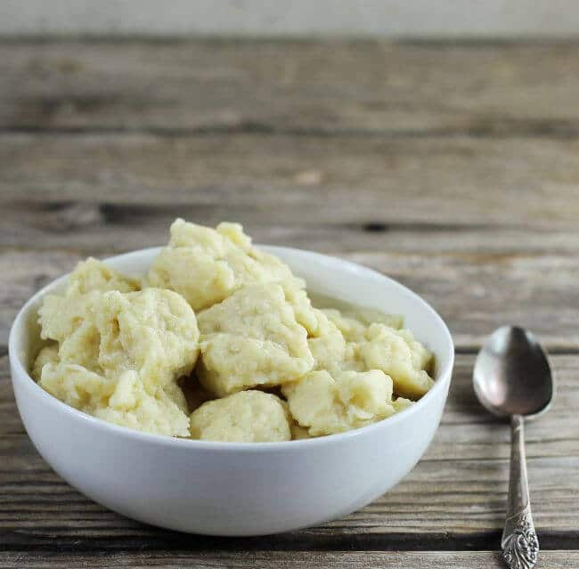 Side view of a bowl with egg dumplings.