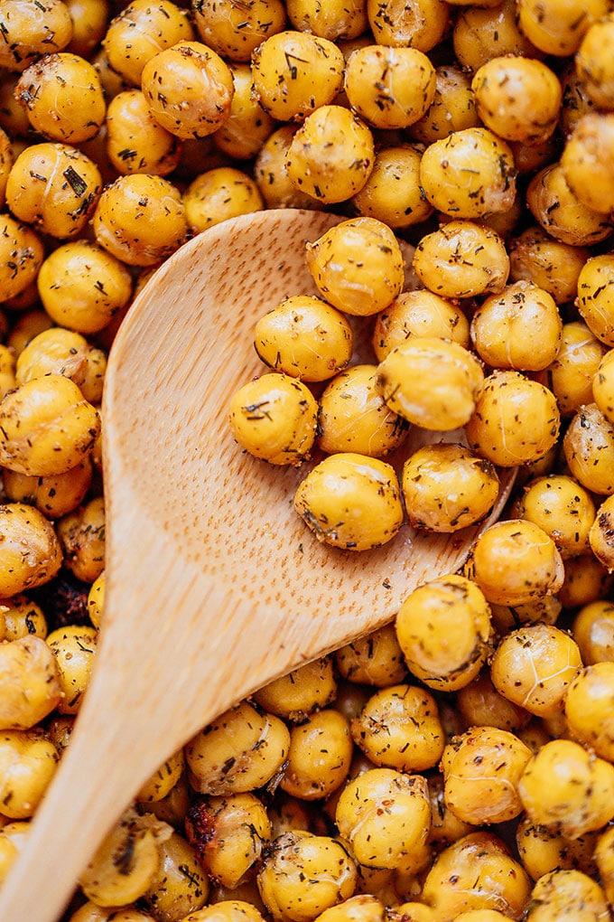 Thick wooden spoon scooping chickpeas