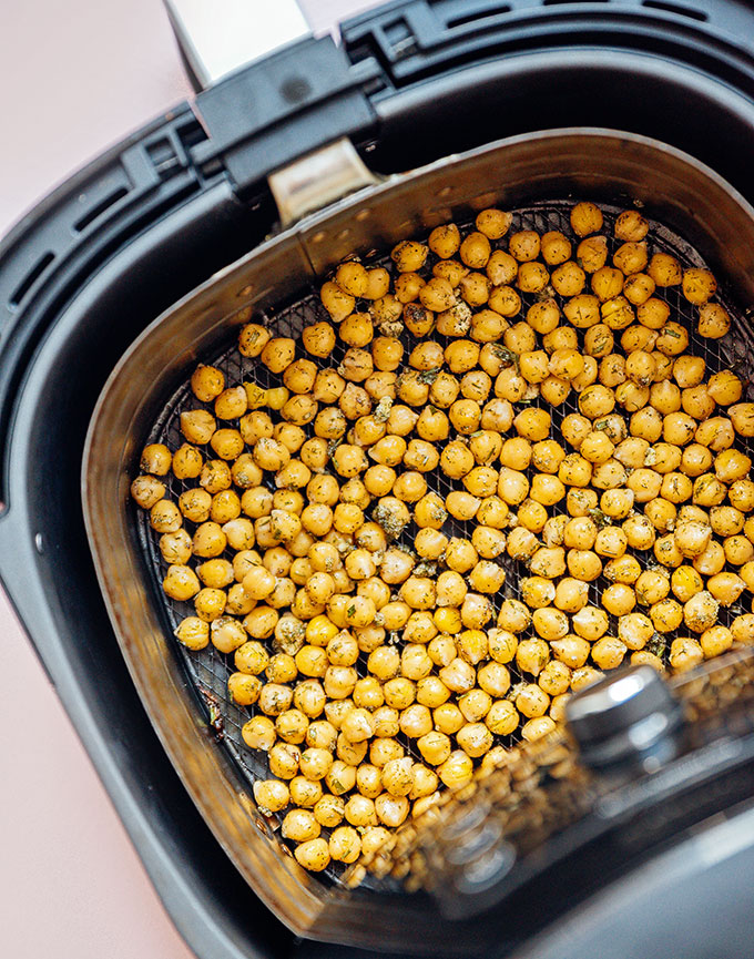 Thick chickpeas line the tray of the air fryer