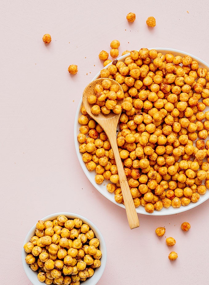 Bowl of chickpeas and plate of chickpeas on a beige background