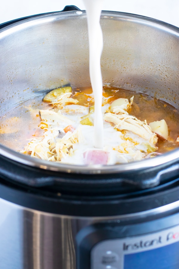 A starchy mixture of almond milk and tapioca starch is poured into the Instant Pot to thicken the vegetable chicken soup recipe.