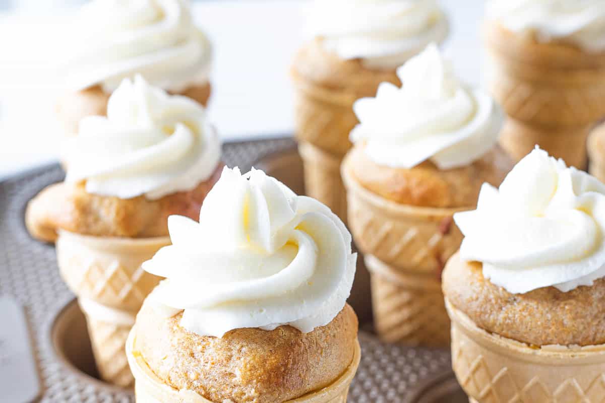 Ice cream cone cupcakes topped with almond butter cream in a muffin box