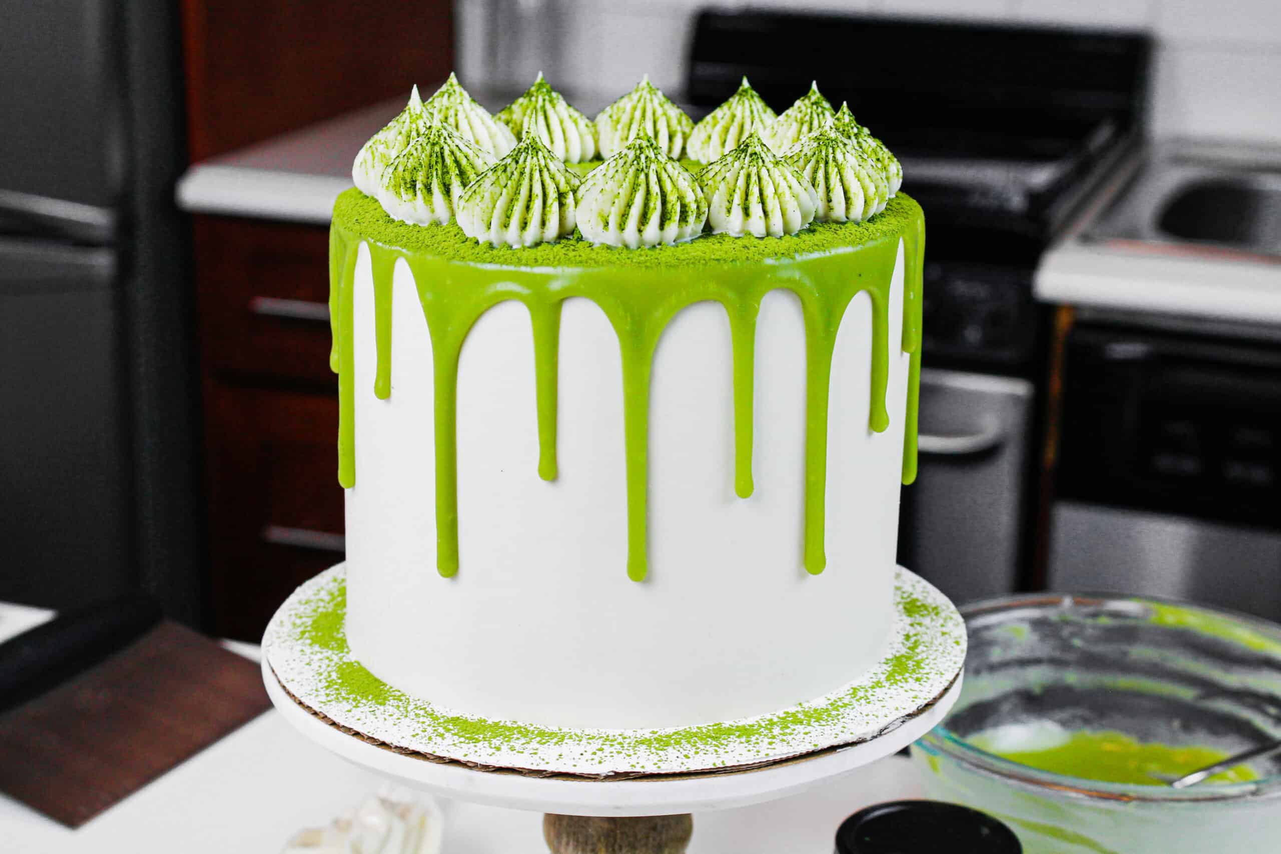 image of a matcha cake with soft buttercream frosting with matcha powder