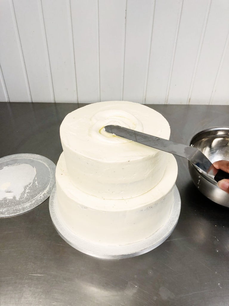 Spread buttercream on the next layer of cake