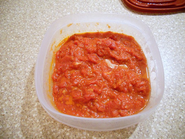 A plastic food storage bowl for leftover pasta sauce.