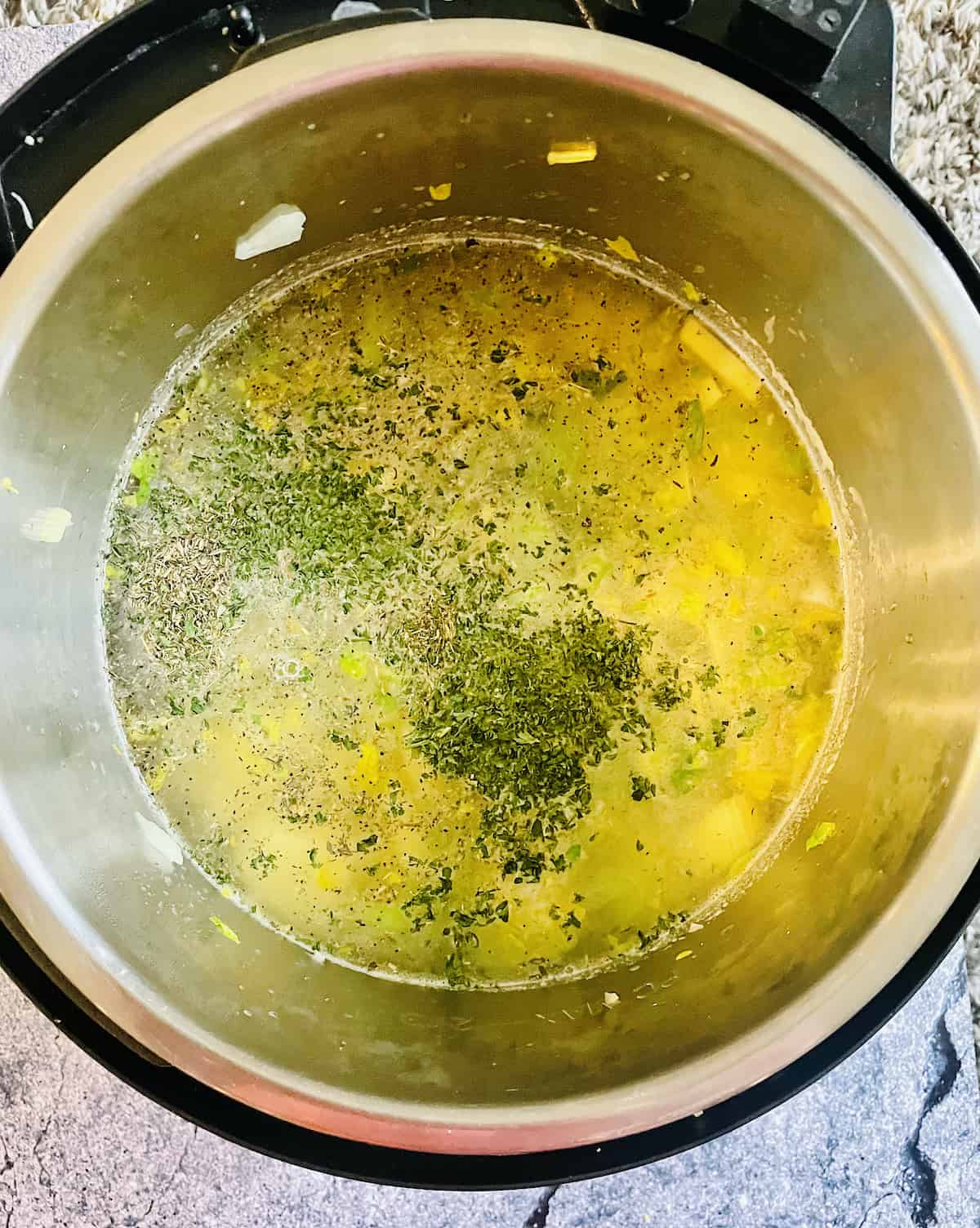 thyme, salt, pepper, broth and potatoes in a pressure cooker