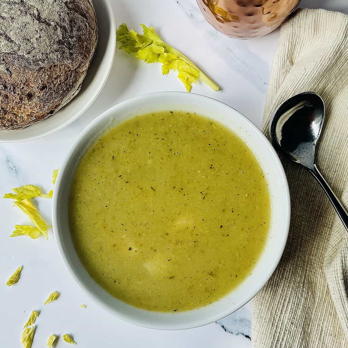 Instant pot of celery soup in a white bowl