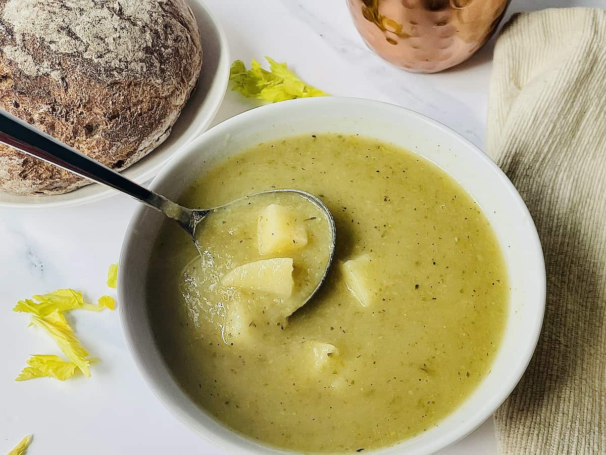 a spoon dipped in celery soup