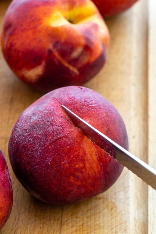 Knife to cut an X into the bottom of a peach