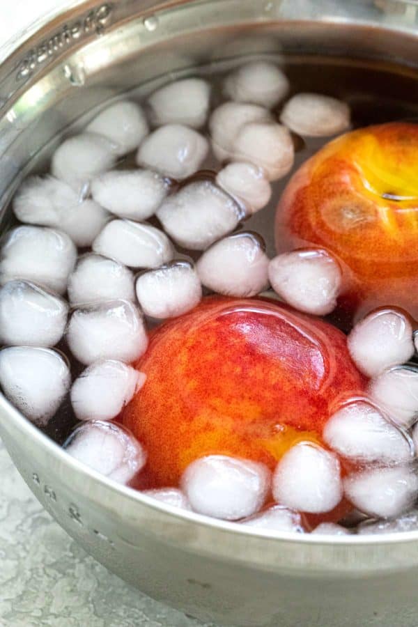 Two peaches in an ice bath