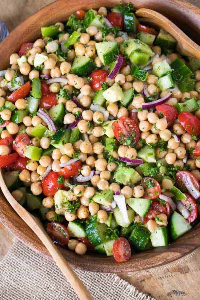 Chickpea salad in wooden bowl with spoon