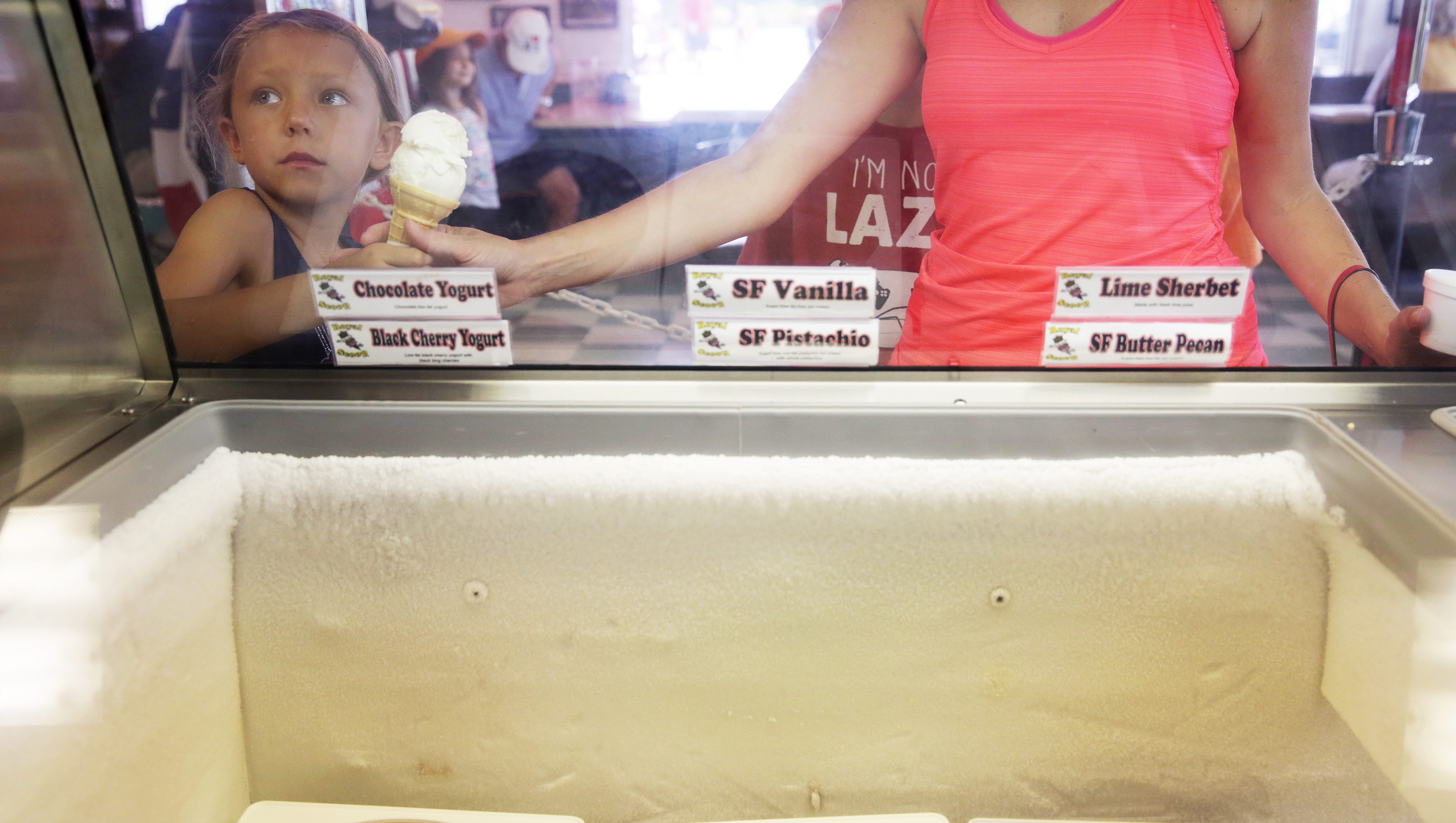 Isla Sloss, 6, of Bonita Springs ate an ice cream cone at Royal Scoop in Bonita Springs on Sunday, July 17, 2016. Royal Scoop hosted an event to celebrate National Ice Cream Day.