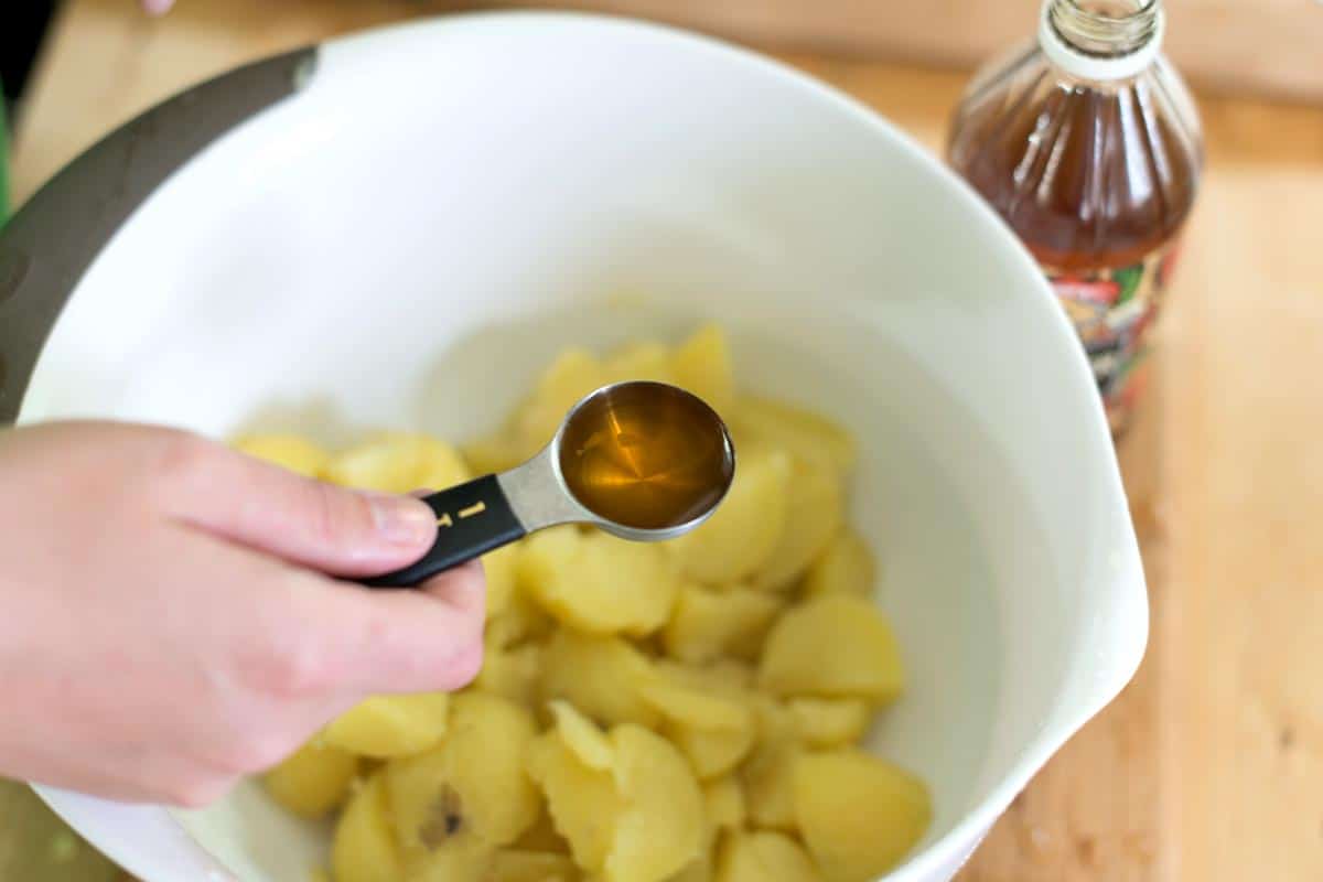 Toss potatoes with vinegar