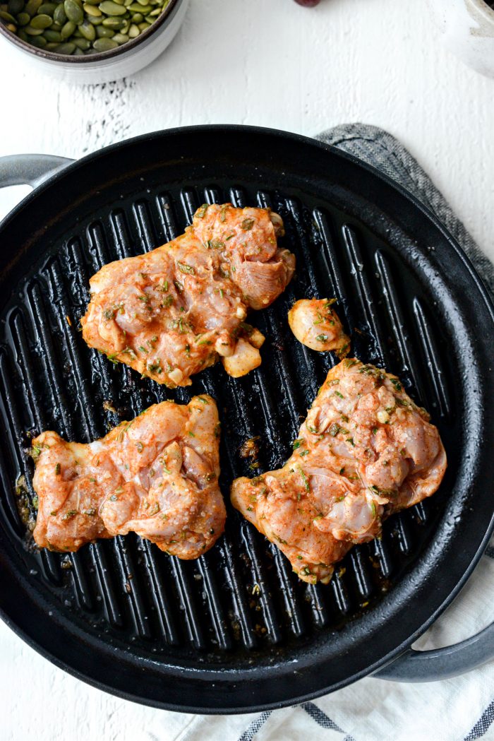 marinated chicken thighs on a baking pan