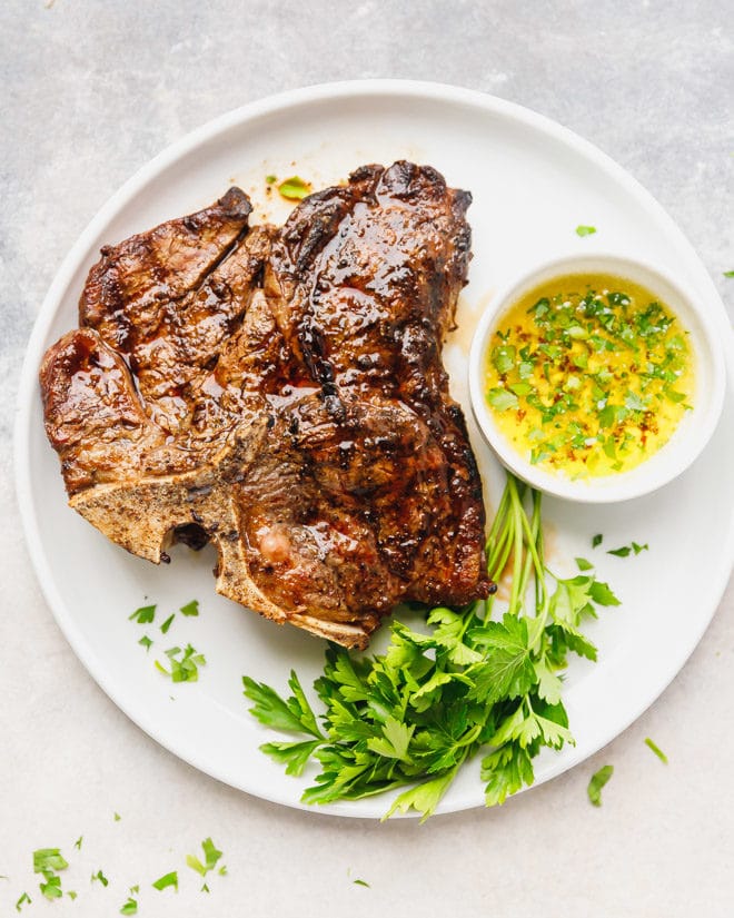 Whole piece of steak on a white cutting board