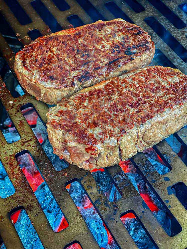 The crust that forms on a New York strip steak as it cooks