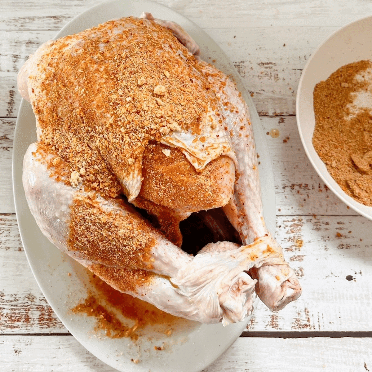 Rub olive oil or butter on entire turkey and cover with dry spice rub with turkey on a platter