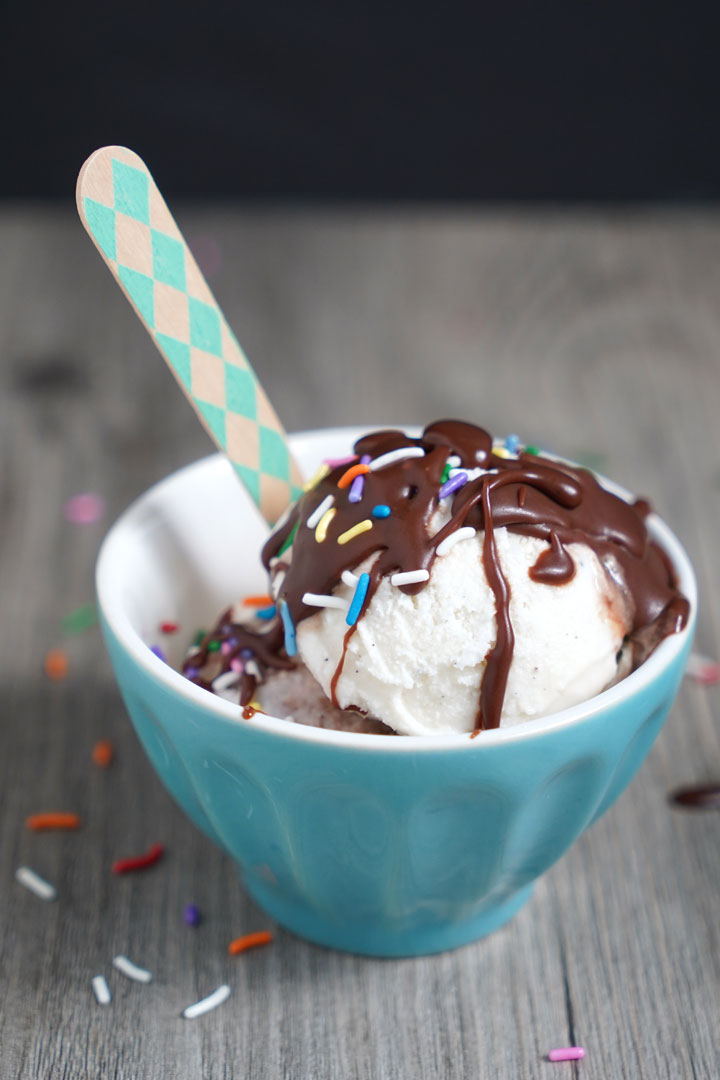 Cream in blue bowl, drizzle with chocolate sauce and top.