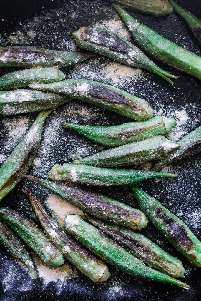 Cornmeal-baked okra in a cast iron skillet.