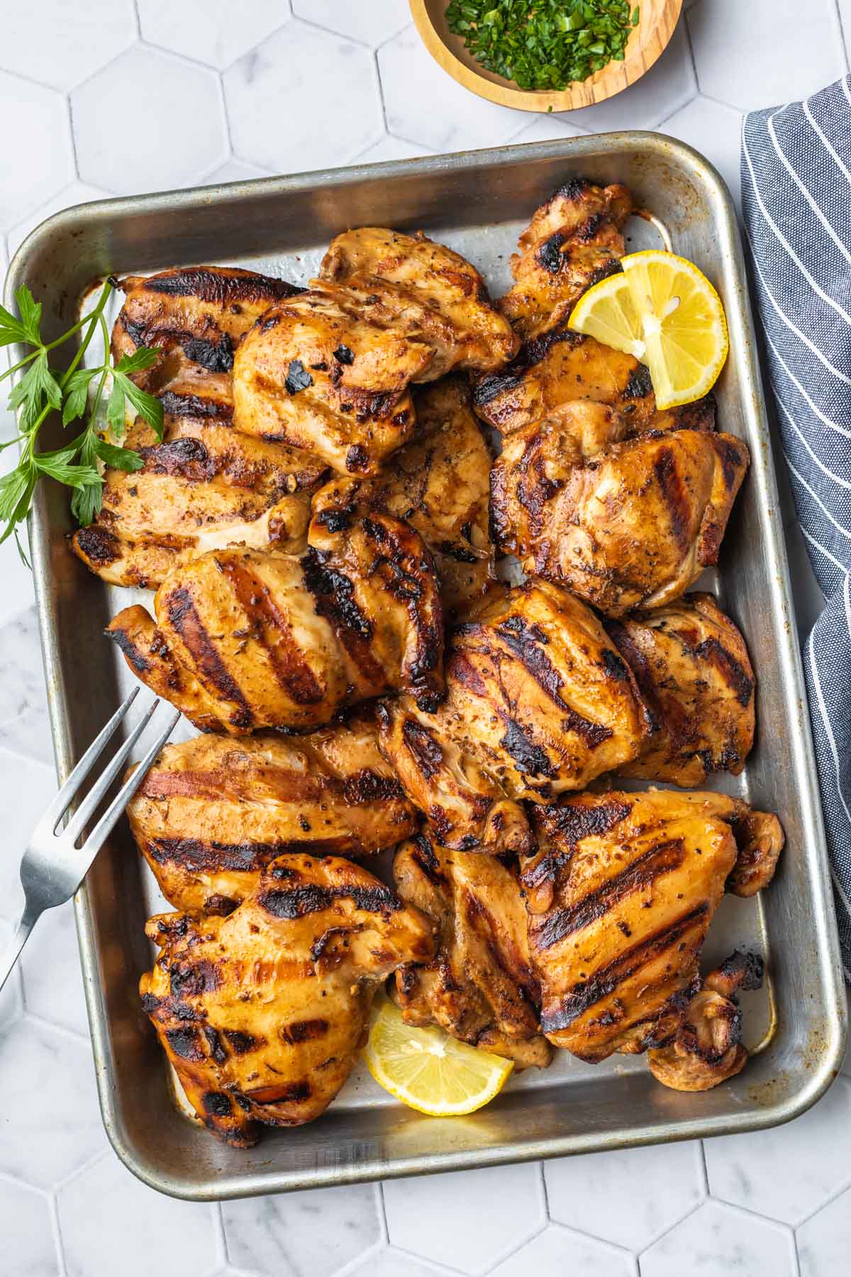 grilled chicken thighs on a baking tray