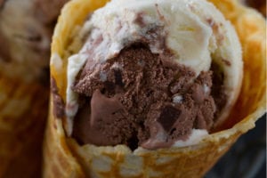 A combination of chocolate and vanilla ice cream in a waffle cone.