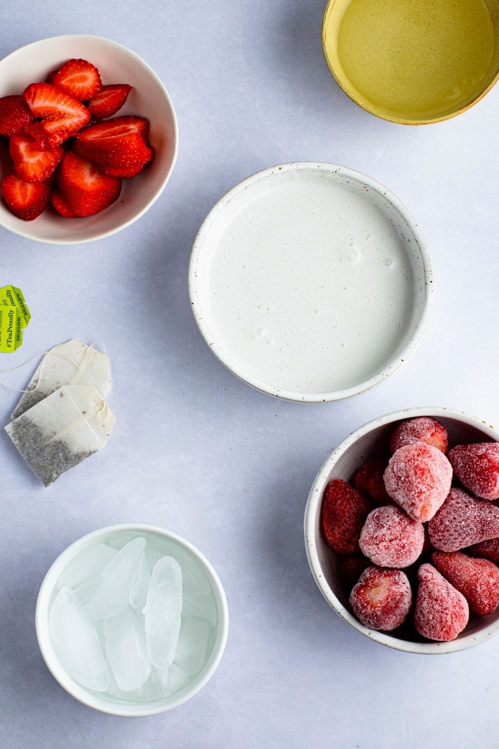 Pour cream into a glass of strawberry juice