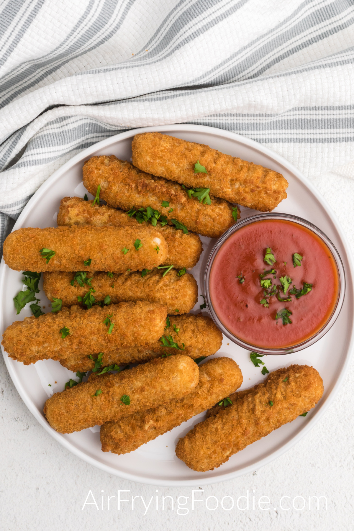 plate full of mozzarella sticks made from frozen in an air fryer