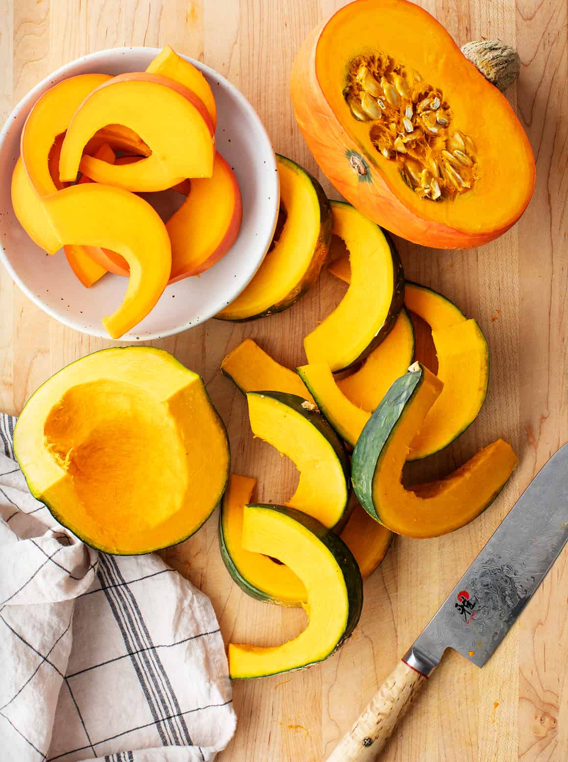 Season kabocha squash on a cutting board