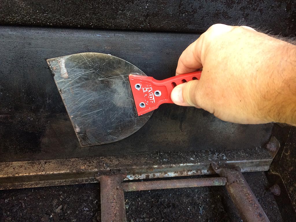 Scrape the top of the firebox with a wide paring knife