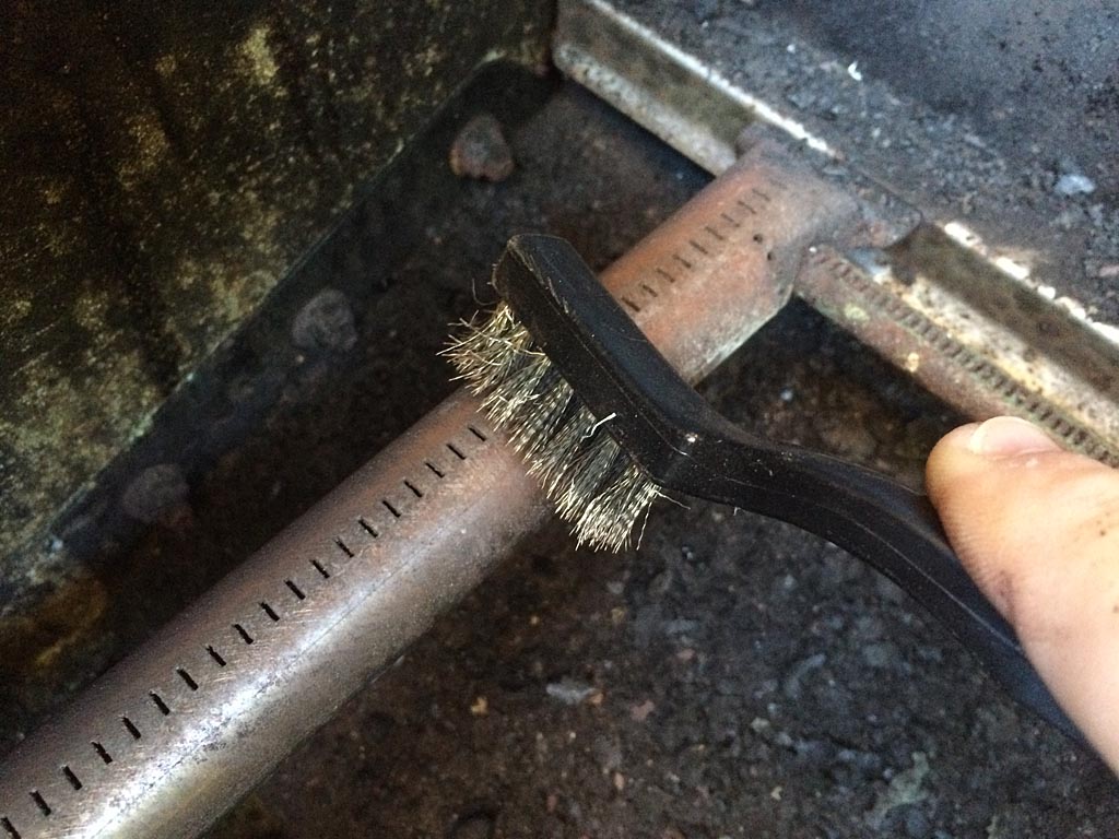 Clean the burner hole with a stainless steel brush