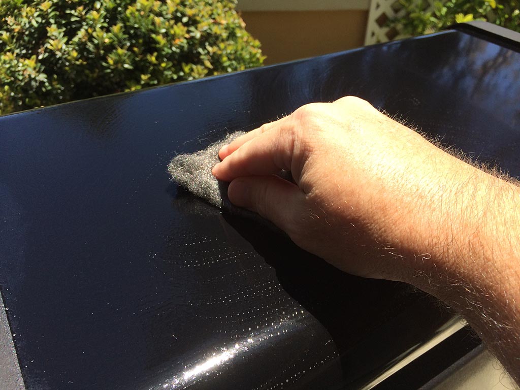Gently scrub the surface with 0000 steel wool and Simple Green