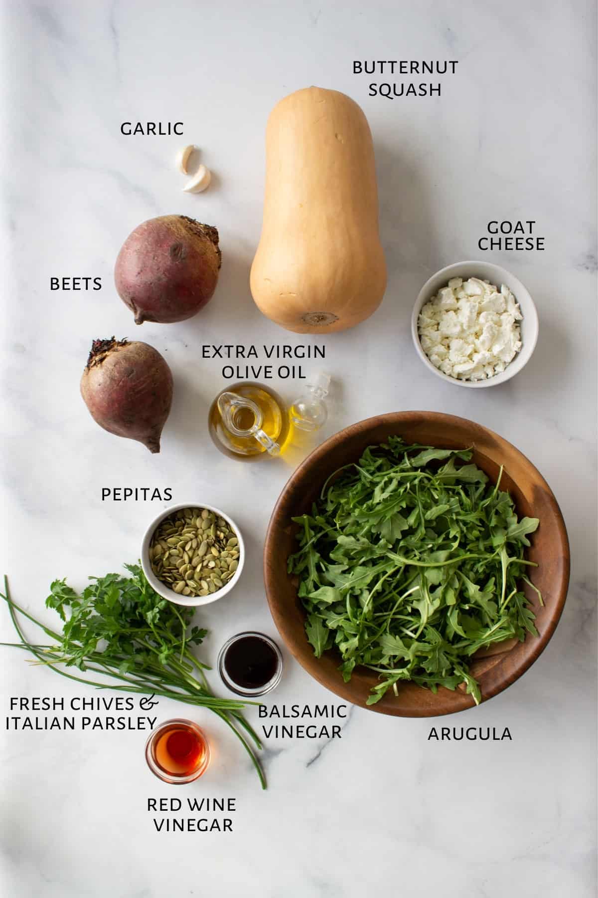 The ingredients for the salad were laid out on a marble countertop.