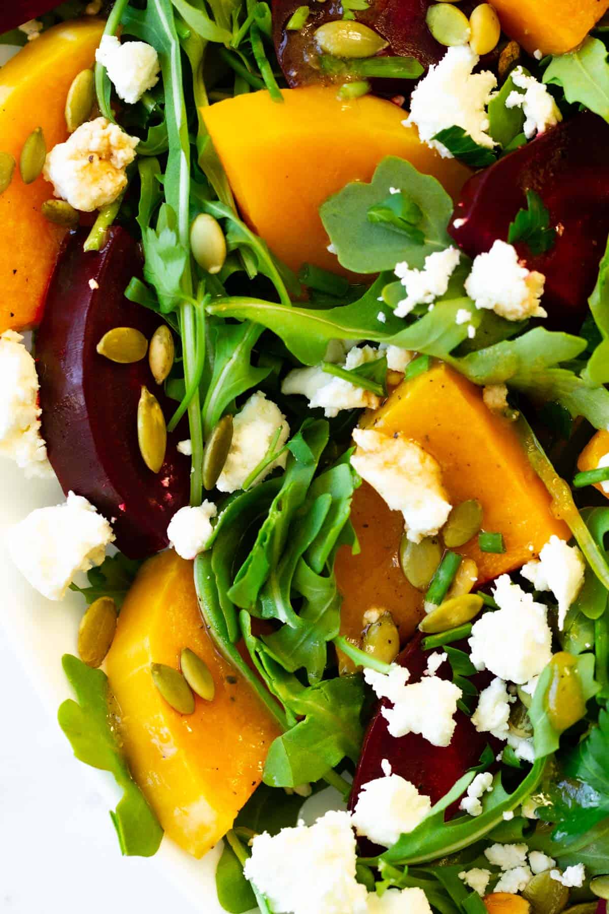 Sliced ​​roasted radish and grilled pumpkin with arugula, pepitas and cheese.