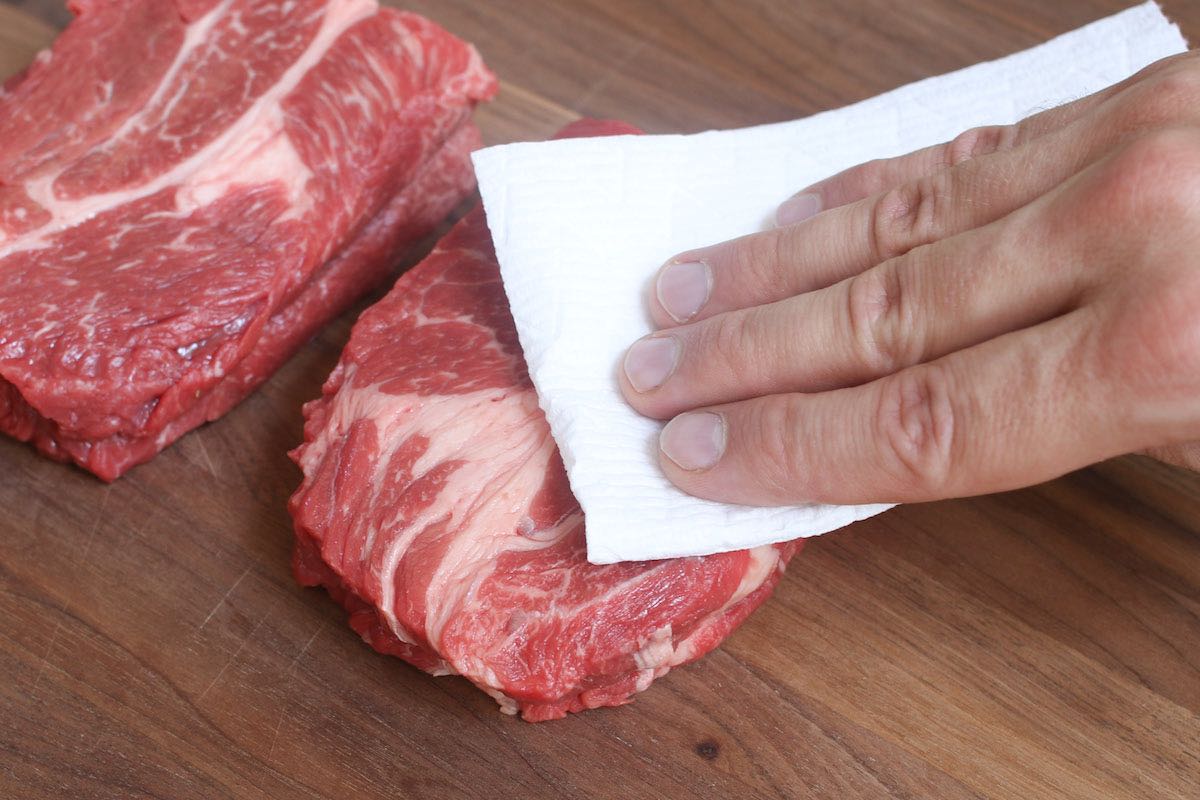 Dry the chuck eye steak with a paper towel to remove excess moisture that can interfere with the drying process