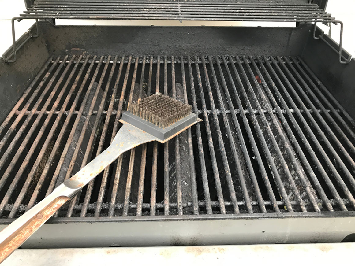 metal barbecue brush on the grill