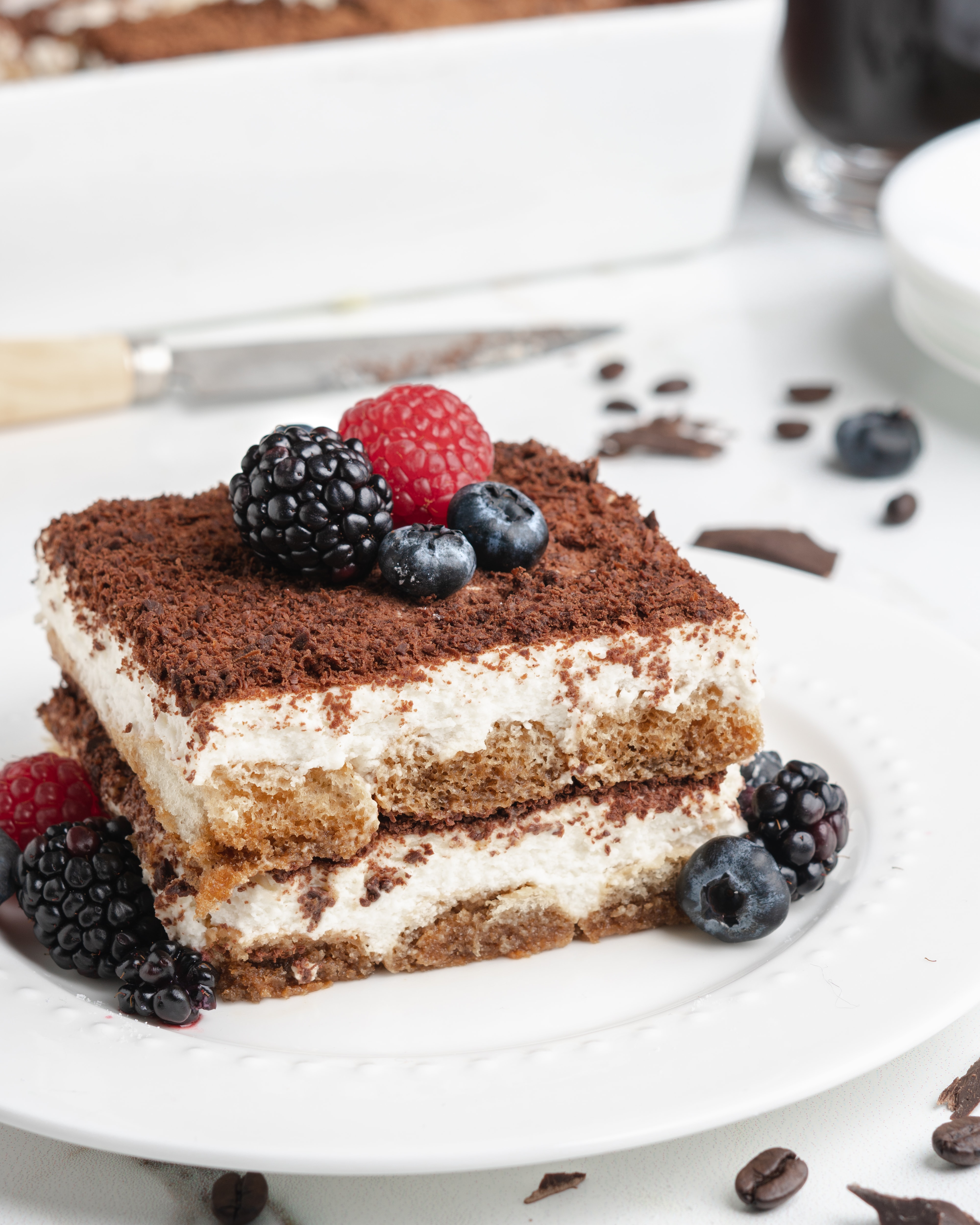 A slice of delicious no-bake cream tiramisu topped with fresh berries