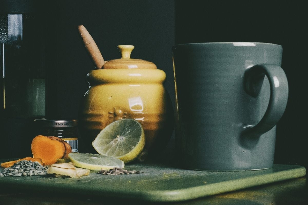lemon, turmeric, honey next to jug