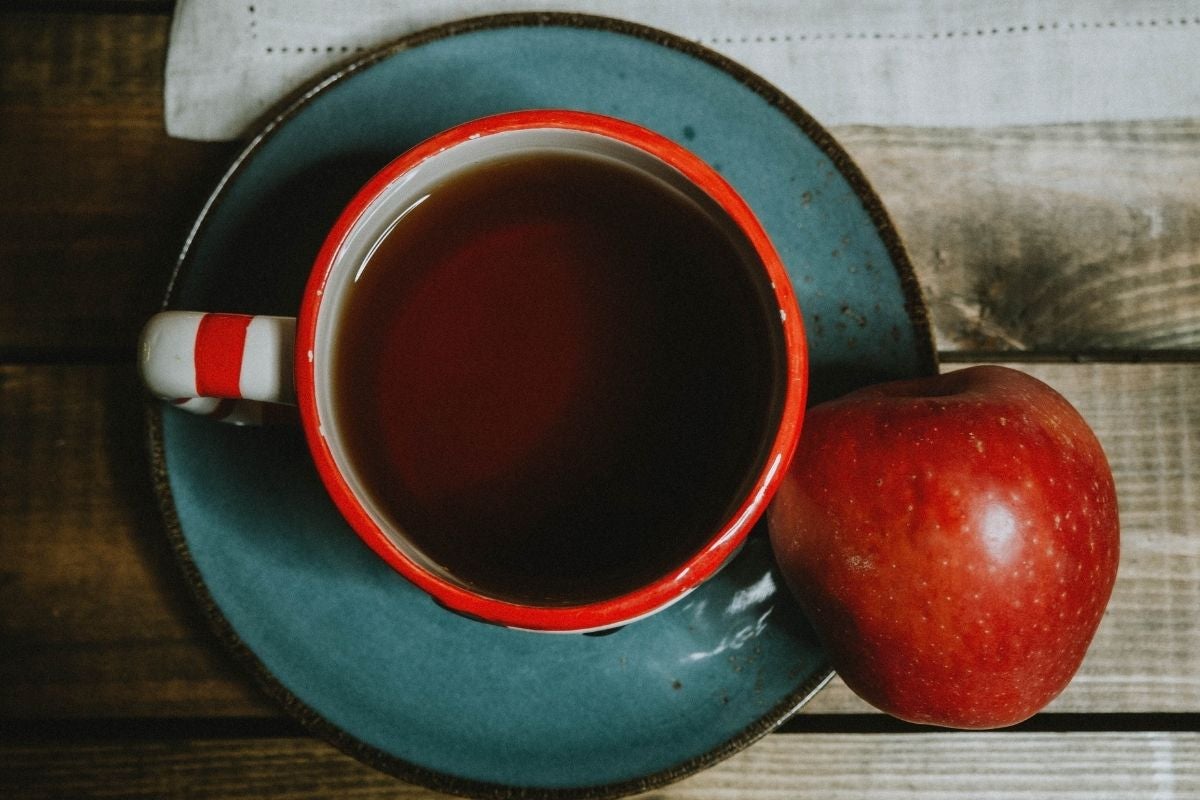 apple next to cup of tea