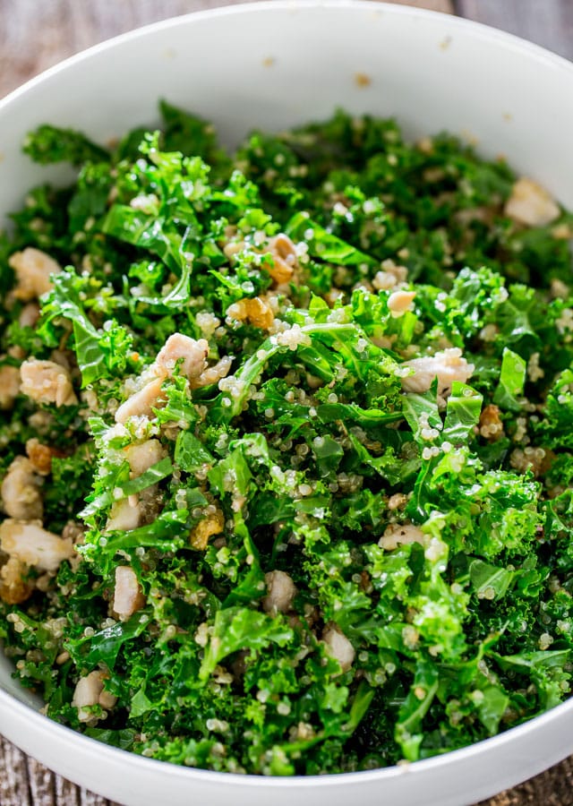 Kale and quinoa salad with lemon Vinaigrette in a white bowl