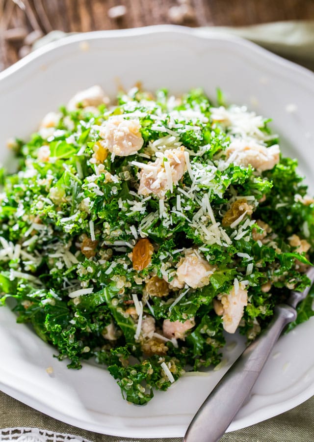 Kale and Quinoa Salad with Lemon Vinaigrette on a white plate with fork