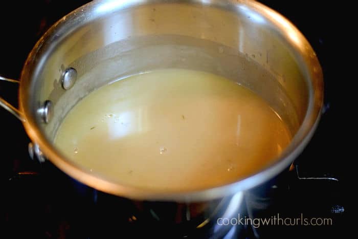 Beef broth boils in a pan.