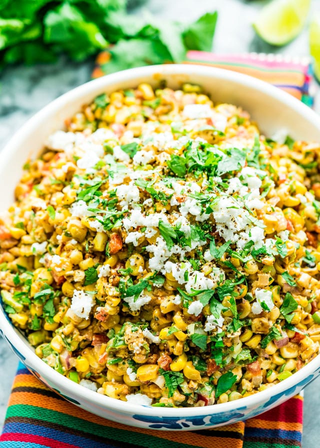 Mexican street corn salad in a bowl topped with cotija cheese and parlsey