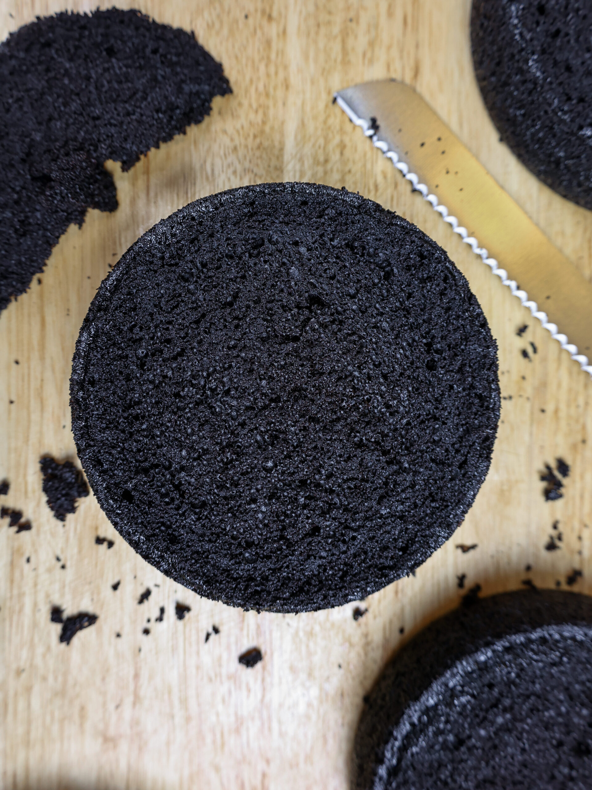 image of chocolate cake layers being stacked by chelsey white of chelsweets