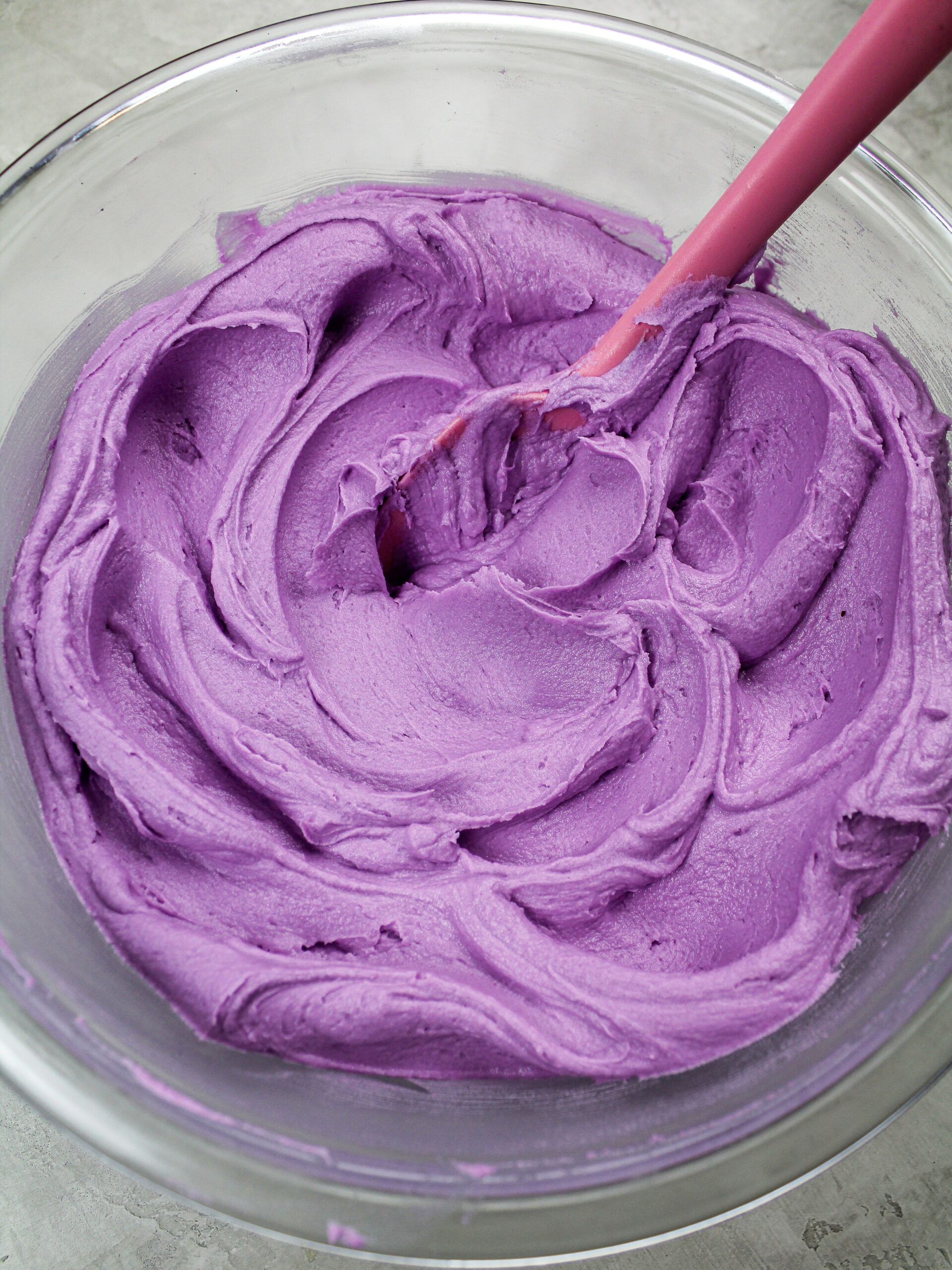 image of a cake being filled with raspberry jam surrounded by a frosting ring