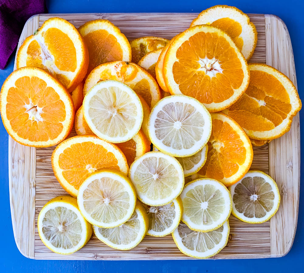 cut lemons and oranges on a cutting board