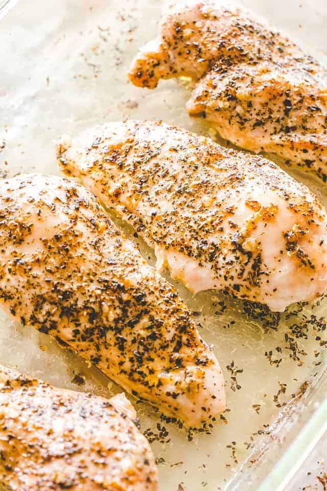 Grill chicken breasts in a baking dish.